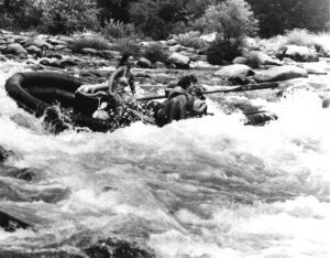 Graciella Rossi rowing ETC raft in Mother Rapid on the Stanislaus River, 1975