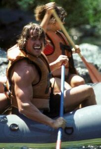 Arnold paddling a raft